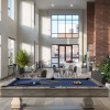 large clubroom rendering showing brick walls, a pool table, modern seating and spacious work areas